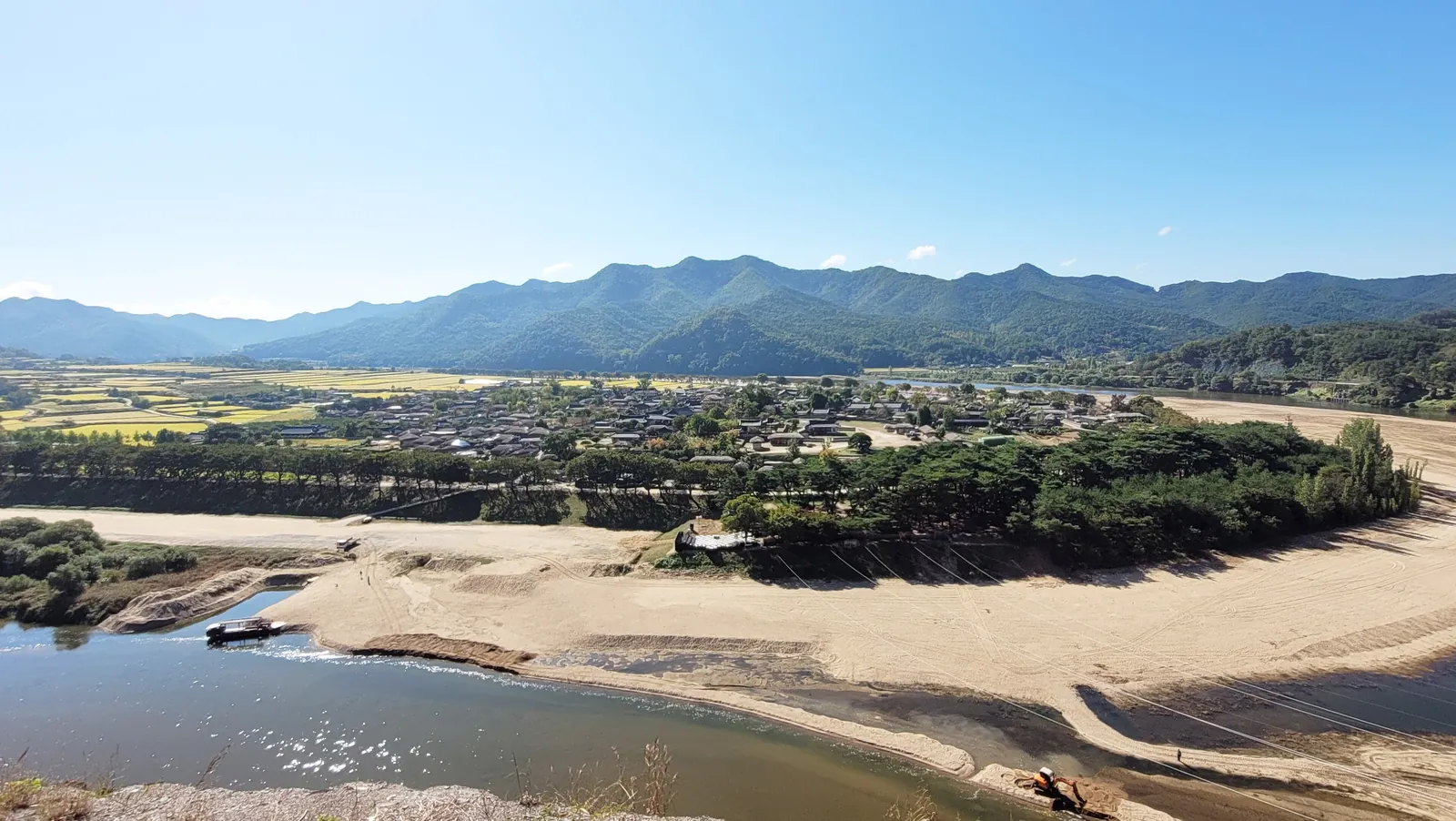 Hahoe Village beyond the sandy bend of the river, with mountains behind, Andong