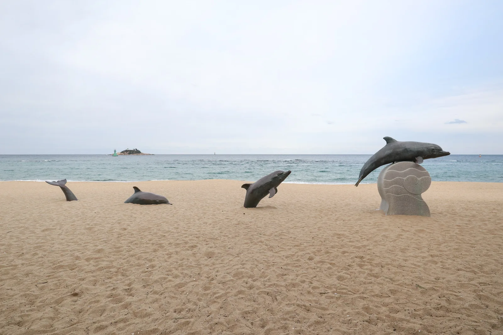 Dolphin sculptures on the sand at Sokcho Beach