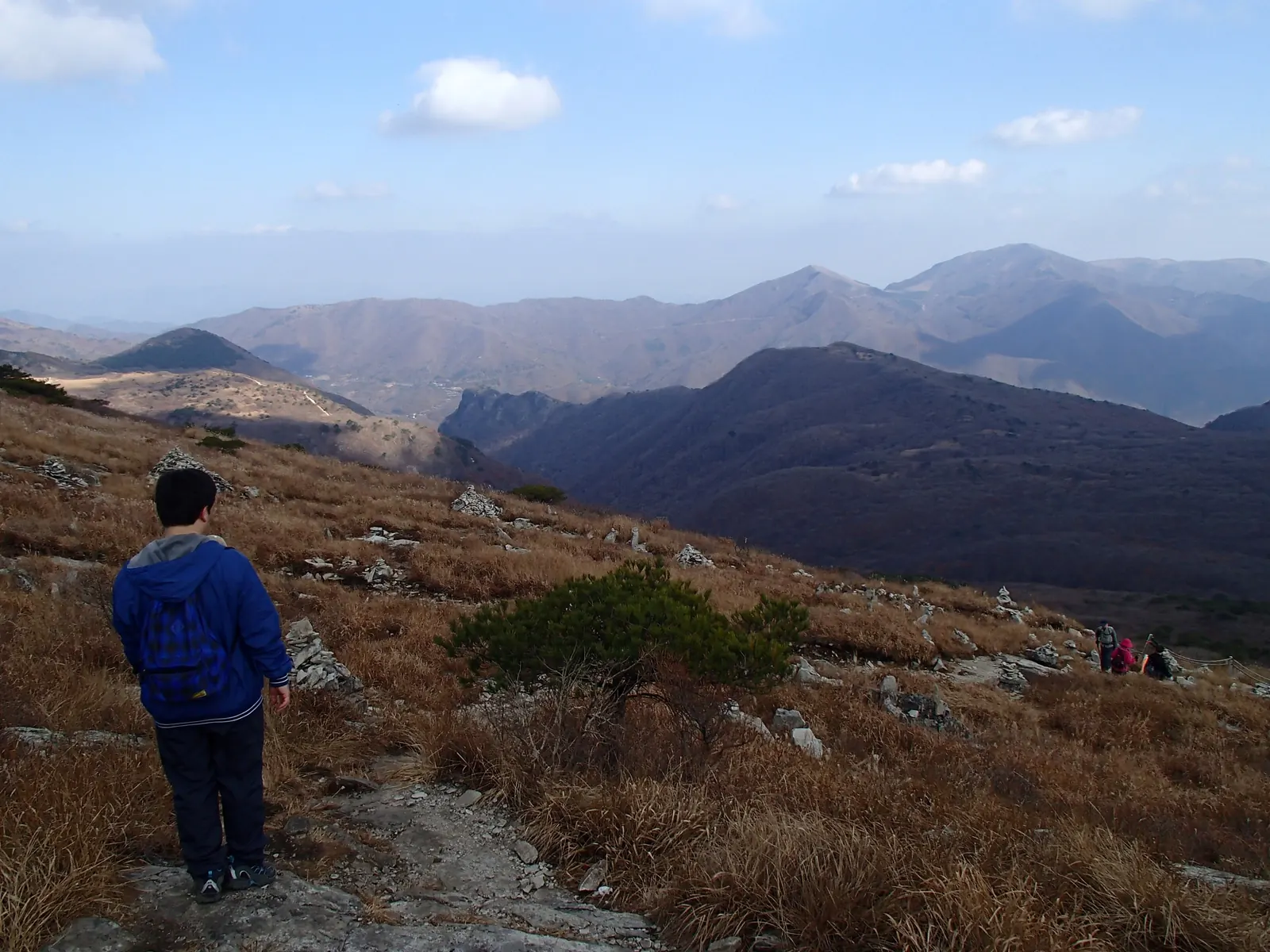 A hiker looking across the autumn ridges of Gajisan in the Yeongnam Alps