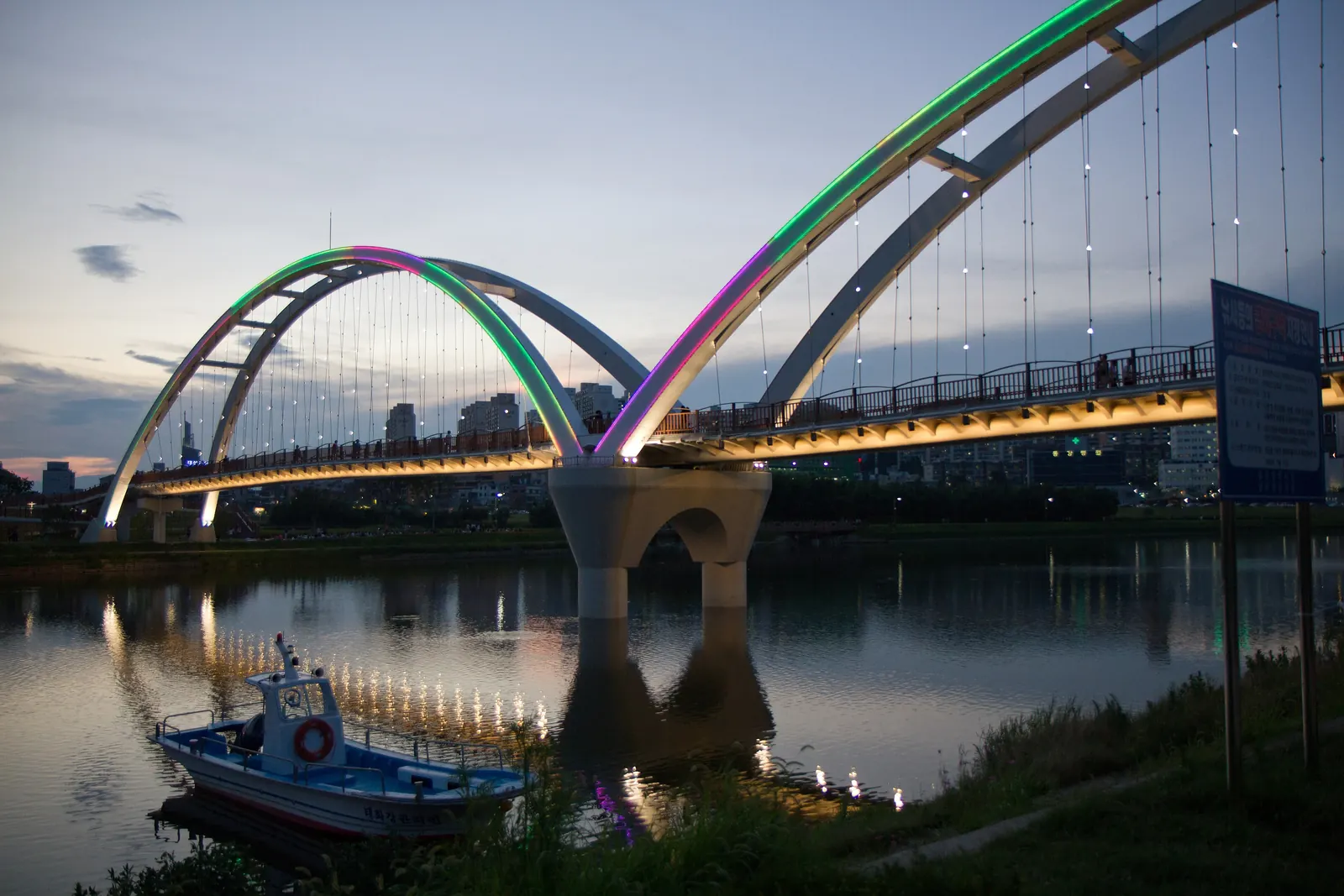 Simnidaebat Bridge lit at dusk over the Taehwa River, Ulsan